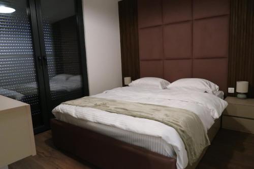 Ένα ή περισσότερα κρεβάτια σε δωμάτιο στο Four Collection