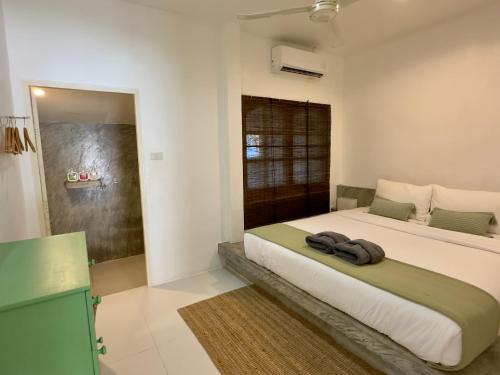 a bedroom with a large bed in a room at Orchid Villa in Koh Tao