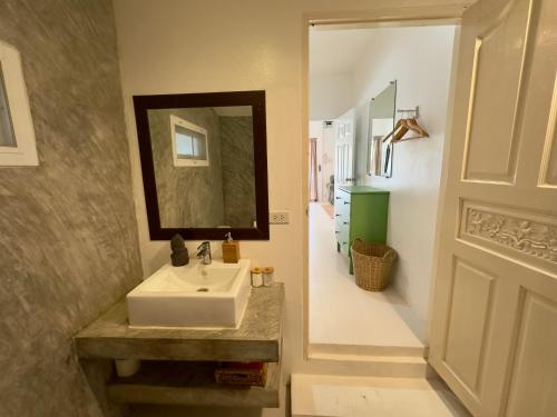 a bathroom with a sink and a mirror at Orchid Villa in Koh Tao