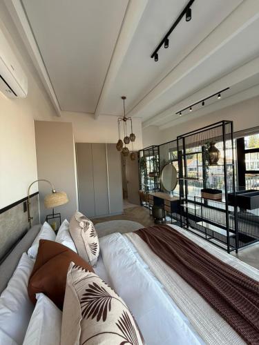a bedroom with a large bed and a desk at Views on August - Penthouse Unit 9 in Cape Town
