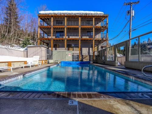 a swimming pool in front of a building at Thunderhead Lodge #301 - Meredith Lodging in Government Camp