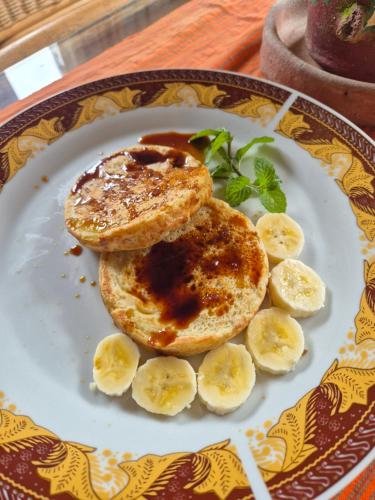 a plate of pancakes with peanut butter and bananas at Serenity homestay in Mamasa