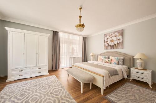 a bedroom with a large bed and a white cabinet at Kaira Homes 2 in Ankara