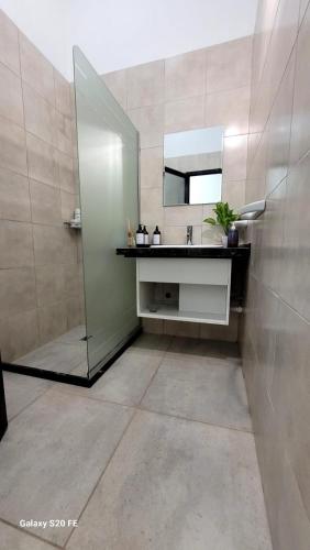 a bathroom with a sink and a mirror and a shower at Aires de Primavera in San Rafael