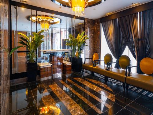 a lobby of a hotel with couches and plants at APA Hotel Nagoya Sakae Higashi in Nagoya