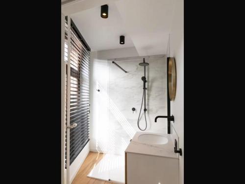 a bathroom with a sink and a shower in it at Holiday home in the heart of Hasselt in Hasselt