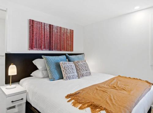 a bedroom with a large bed with pillows on it at Cozy 1-Bed Studio Near Cafes and Shops in Carnegie