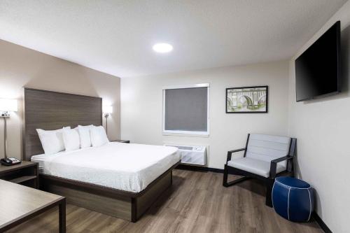 a hotel room with a bed and a chair at Extended Stay America Suites - Columbia - Greystone in Columbia