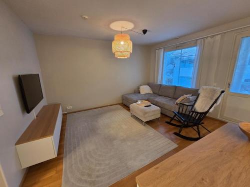 a living room with a couch and a table at The Arctic Nordic Retreat in Rovaniemi