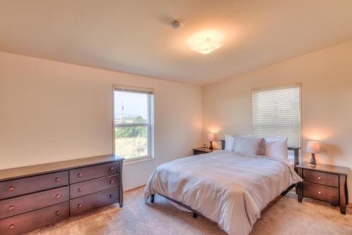 a bedroom with a bed and a window and a dresser at Starboard Cottage in Waldport