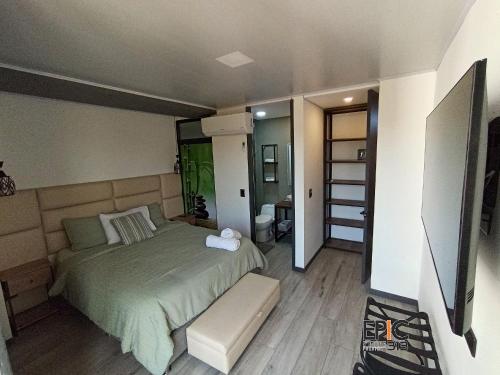 a bedroom with a bed and a television in it at Epic Suite 313 Deluxe Airport Family 3H 10P in Cuba