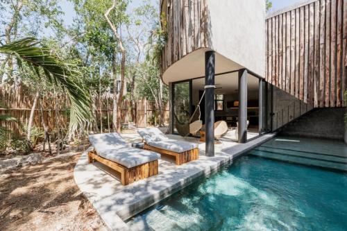 a house with a swimming pool next to a house at Esencia Villas Tulum Priv Pool Concierge in Tulum