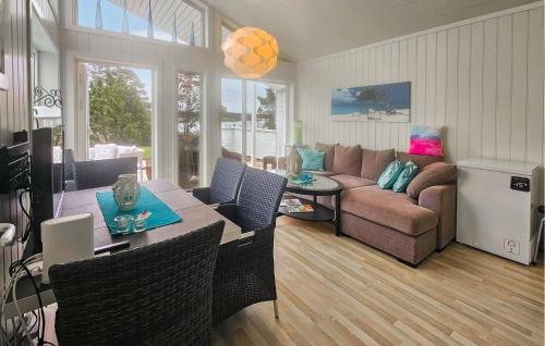 a living room with a couch and a table at Stunning Home In Tjøme With Private Swimming Pool, Can Be Inside Or Outside in Nord Måkerøy