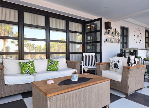 a living room with a white couch and a table at The Pervoli Studio - Pool - Close to Beach in Larnaca