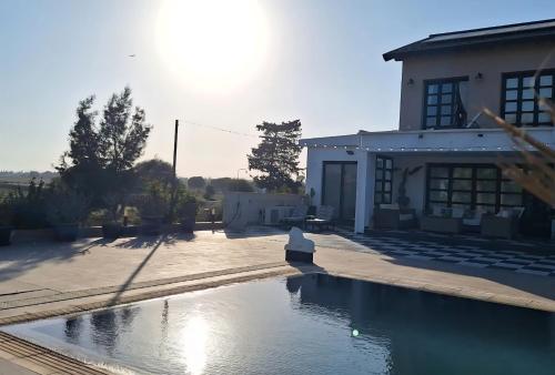 a house with a swimming pool in front of a house at The Pervoli Studio - Pool - Close to Beach in Larnaca