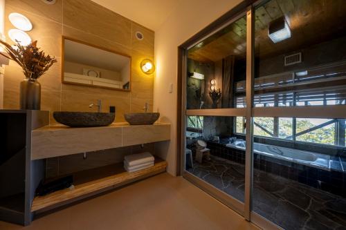 a bathroom with two sinks and a large window at tomaru wool -moku- in Atami