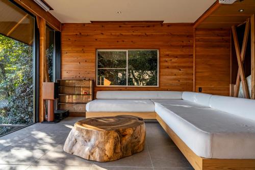a living room with a tree stump coffee table at tomaru wool -moku- in Atami