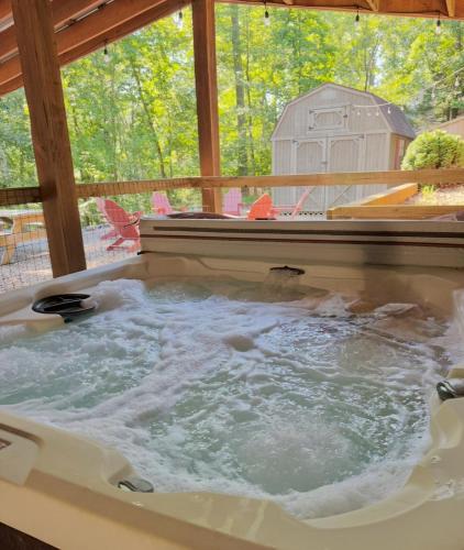 a jacuzzi tub in a house with a barn at Eagle Mountain River Retreat in Ellijay