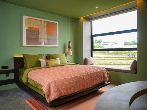 a bedroom with a bed and a large window at Patha Canggu in Canggu