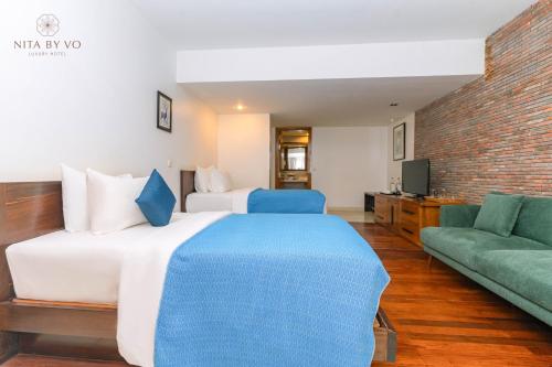 Postel nebo postele na pokoji v ubytování Nita By Vo Luxury Hotel