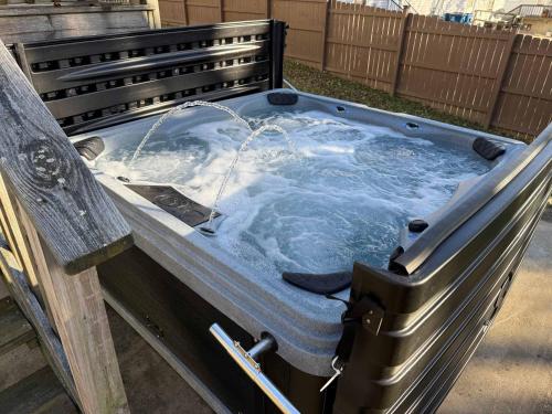 a hot tub sitting on a bench with a fountain at 4BR for 10, Near Ark, High-Tech Kitchen, Parking! in Williamstown