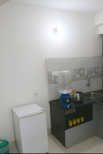 a small kitchen with a counter and a mixer at ISKCON Mayapur Apartments - Daily & Monthly Rentals- PRIME LOCATION - SERVICED Apartment, 5 MIN to MAIN ISKCON TEMPLE in mayapur