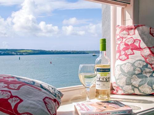 a bottle of wine sitting next to a glass at Haven View in Neyland