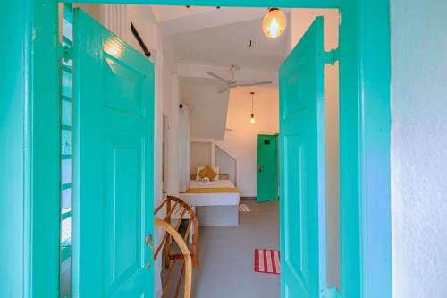 a room with a green door and a table at Istana Villa Mirissa in Mirissa