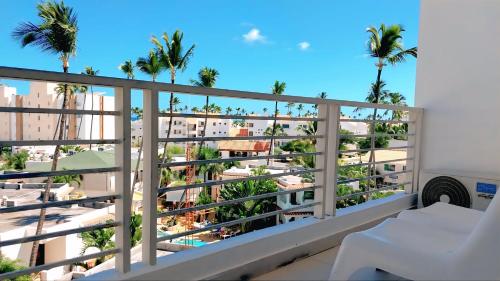 a view from the balcony of a condo with palm trees at Punta Cana Aruba Beach Apartcomplex 1 in Punta Cana