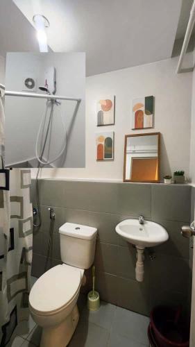 a bathroom with a toilet and a sink at 2 Bedroom Condo UDH by ZX Homes Banilad in Mandaue City