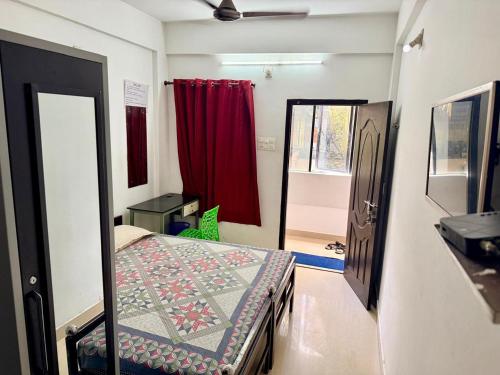 a room with a bed and a door with a window at Siva Inn in Guruvāyūr