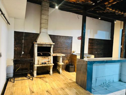 a large room with a fireplace and a table in it at Quarto privativo para cop 30 in Ananindeua