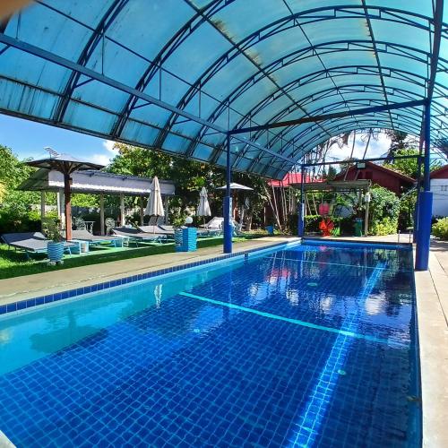 a large swimming pool with a clear canopy over it at Thai Garden​ Resort​ Kanchanaburi​ in Kanchanaburi City