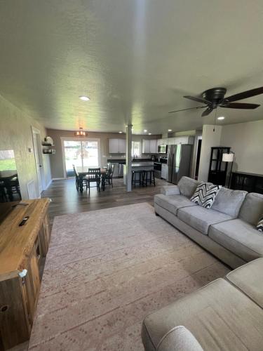 a living room with a couch and a table at Rest and retreat river house in Grants Pass