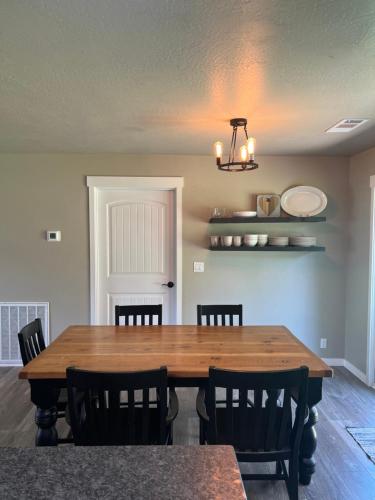 a dining room with a wooden table and chairs at Rest and retreat river house in Grants Pass
