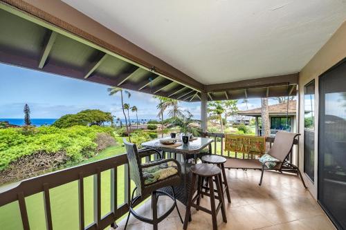 a balcony with a table and chairs and a view of the ocean at Kaanapali Plantation 57 · KPL 57 Hillside Haven | AC + BeachView in Lahaina