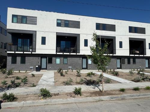 ein großes weißes Gebäude mit Balkon auf einer Straße in der Unterkunft 4BR Townhome near Downtown-SLC Airport in Salt Lake City