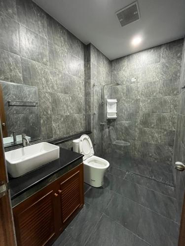 a bathroom with a sink and a toilet and a shower at Cozy Corner in Samut Prakan