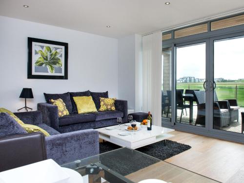 a living room with a couch and a table at Fistral View - 3 Cribbar in Newquay
