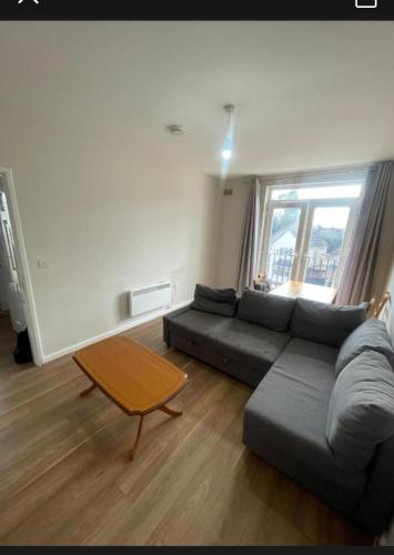 a living room with a couch and a table at Flat 9 Haden in Wolverhampton