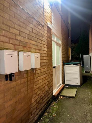 a brick building with a door and a window at Flat 9 Haden in Wolverhampton