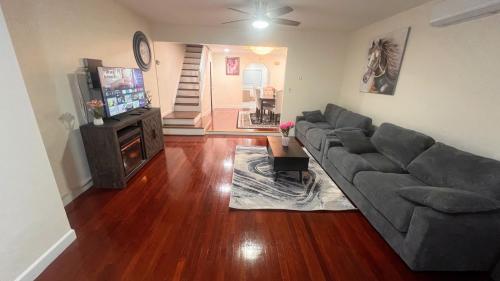 a living room with a couch and a television at Amazing private single family house in Glendale