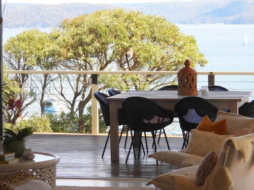 a table on a deck with a view of the water at Lola in Palm Beach