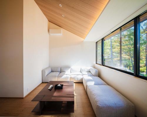 a living room with a couch and a table at Kamuy Chalet Hakuba by Jade Group in Hakuba