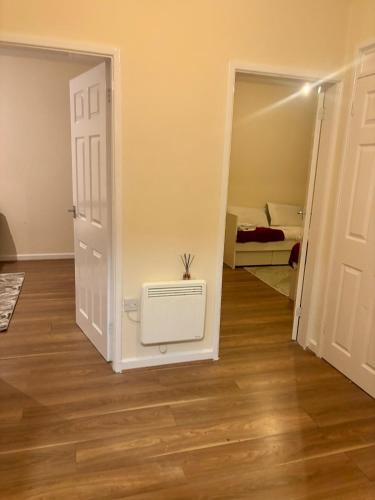 a room with a door and a room with a heater at Flat 8 Larches lane in Wolverhampton