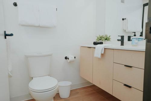 a bathroom with a toilet and a sink at The Downtown Lookout DT Gym free parking in Salt Lake City