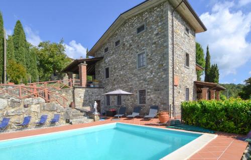 a house with a swimming pool in front of a building at Amazing Apartment In Caprese Michelangelo in Caprese Michelangelo