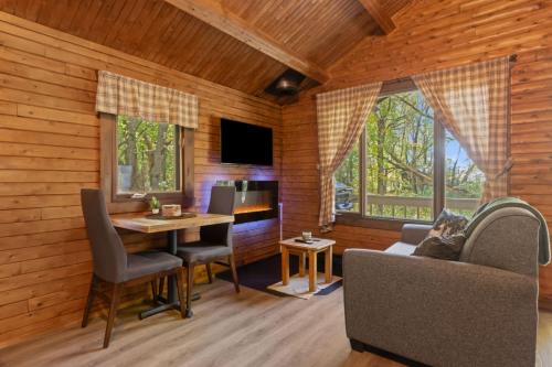 a living room with a table and a couch at chalet 4 - Domaine de l'Archipel in Sorel