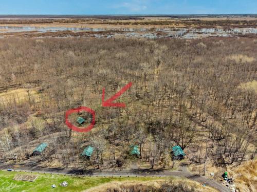 an overhead view of a field with trees and red writing at chalet 5 Domaine de l'Archipel in Sorel