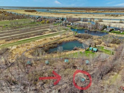 an aerial view of a farm with red graffiti on it at chalet 5 Domaine de l'Archipel in Sorel